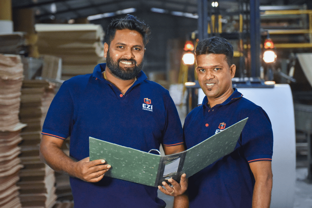 EZI Packaging team reviewing corrugated packaging design at manufacturing facility in Sri Lanka
