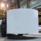 Forklift moves a large roll of paper at EZI factory
