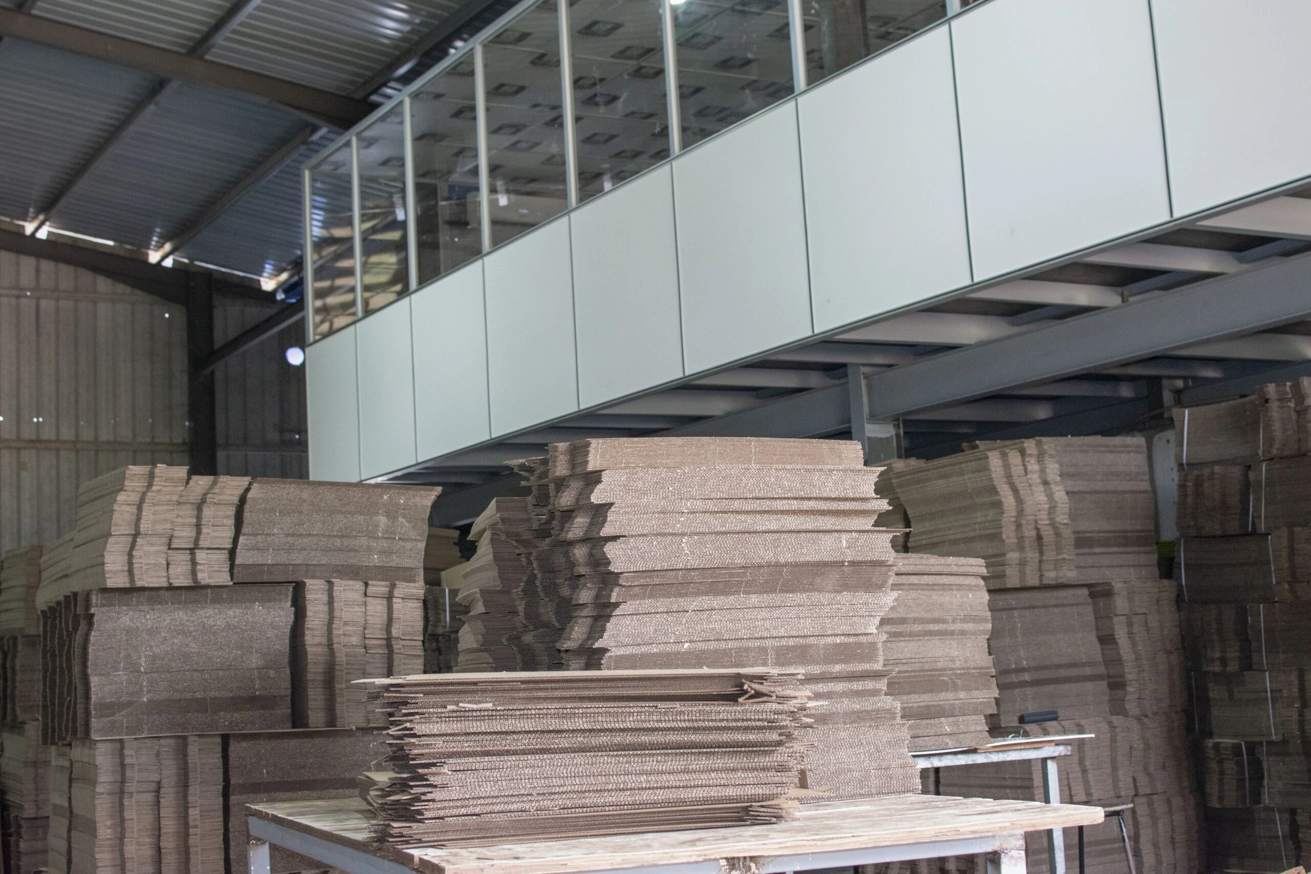 Stacks of cardboard sheets at EZI Packaging